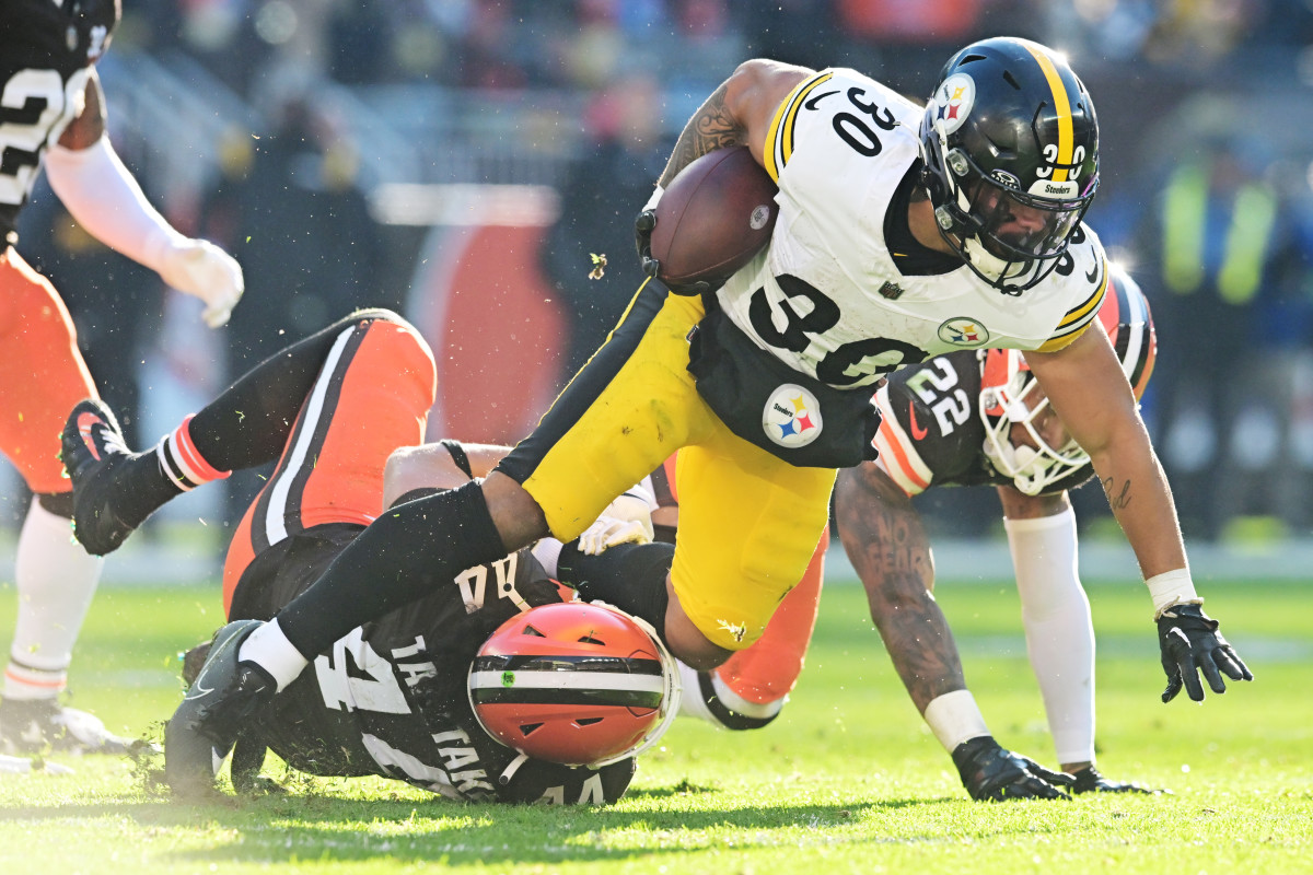 Jaylen Warren tries to run through a tackle against the Browns